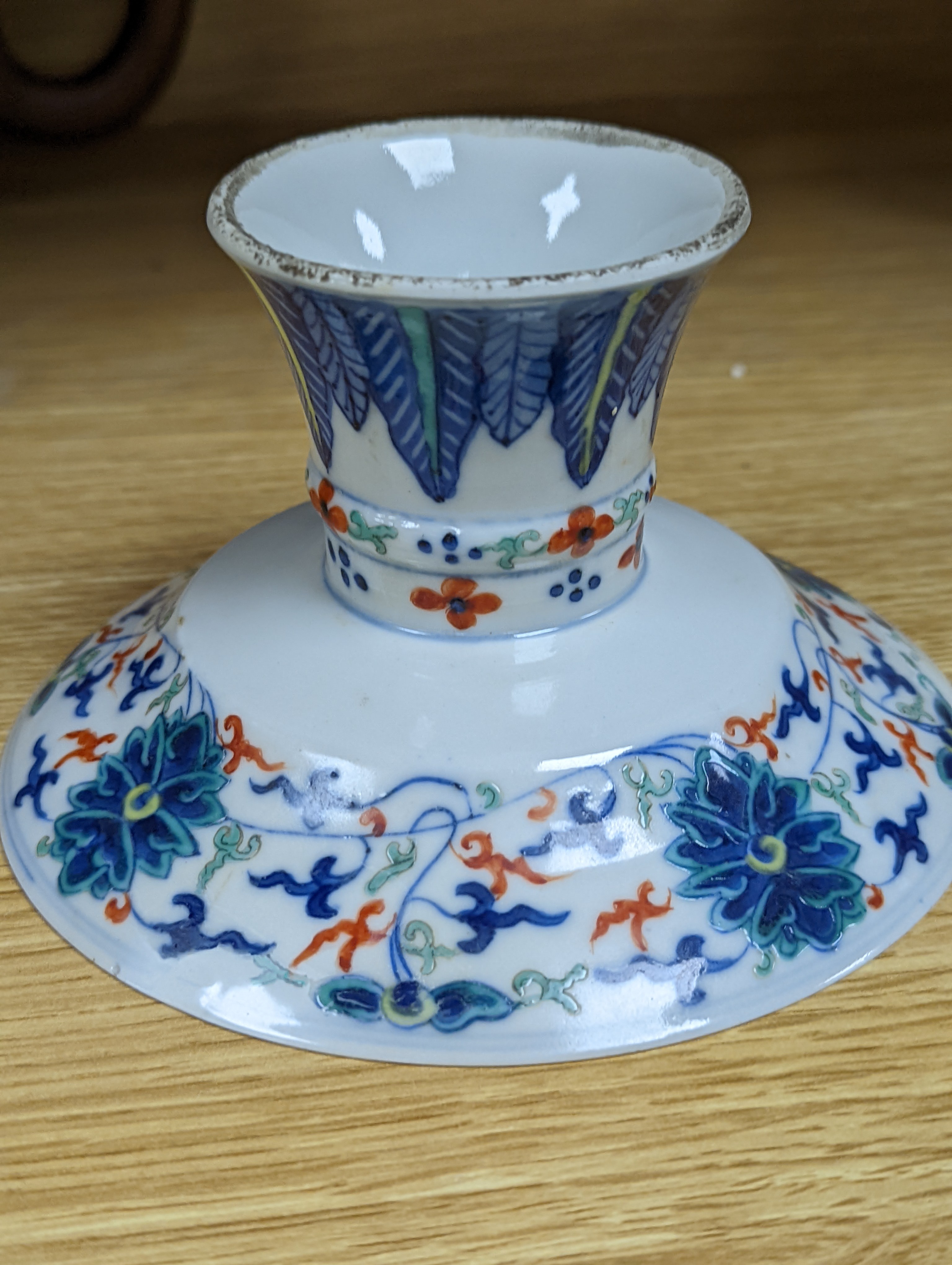 A Chinese blue and white water pipe vessel, a doucai stem dish and a Japanese Imari bowl, 19th century, (3)